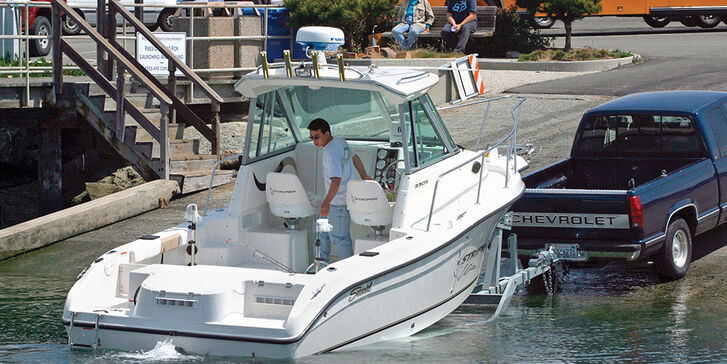 Fishing boat being launched at launch ramp