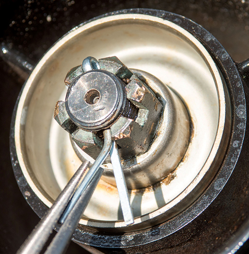 person replacing the cotter pin in the prop nut