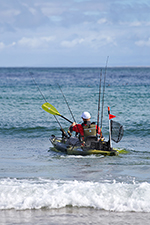 person paddling out past the surf