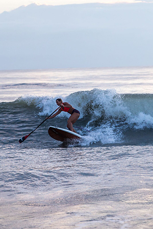 SUP surfer performing a bottom turn