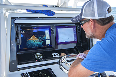 Angler looking at multi-function displays