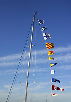 Nautical code flags raised above sailboat