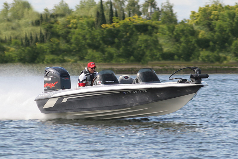person driving a bass boat