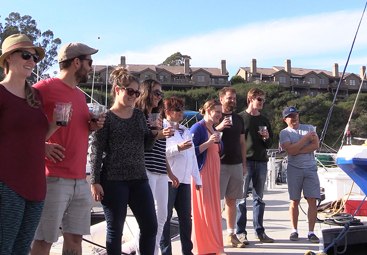 friends on the dock watching the christening