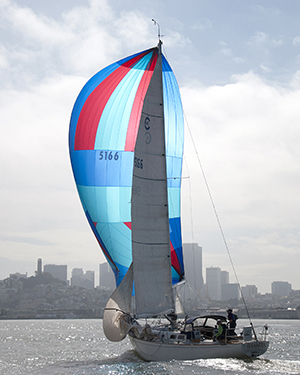 Sailboat with a red and blue 3/4 ounce symmetrical kite