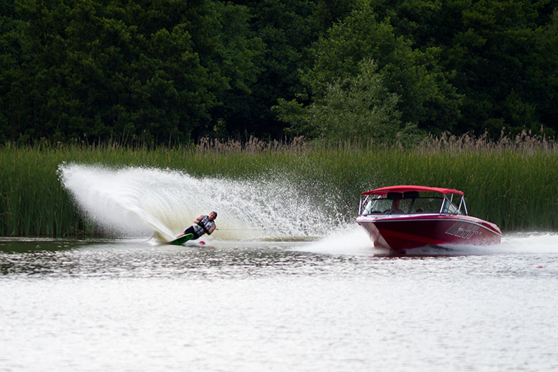 Ski boat pulling a slalom skier