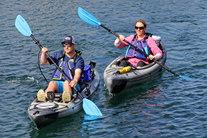 2 people paddling kayaks