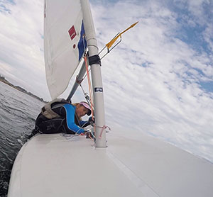 sailor moving across a dinghy during a tack