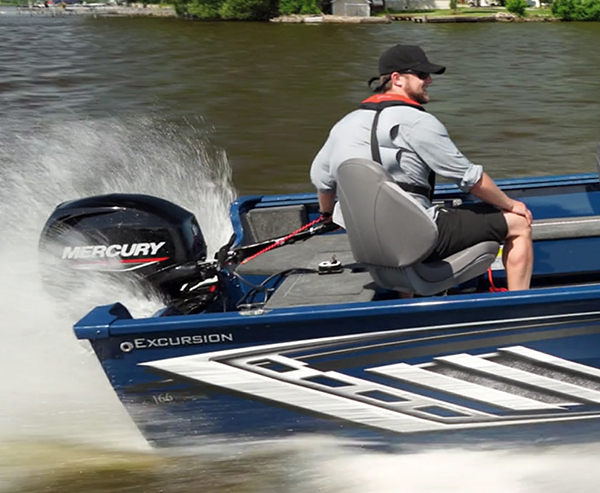 Man steering boat with outboard motor with wrist attached to ECOS device