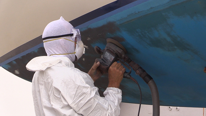 Sanding the hull of the boat