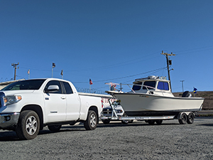 Pickup truck hitched to boat on trailer