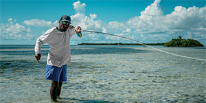 Man flycasting in shallow ocean inshore water