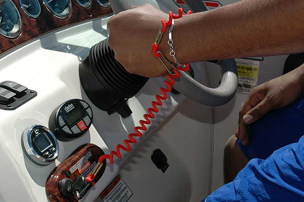 Hand holding steering wheel attached to ECOS device