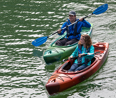 Two kayakers paddling next to each other