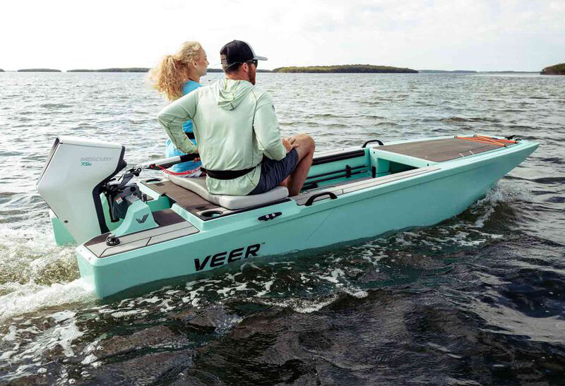 two people on a boat using an electric outboard motor